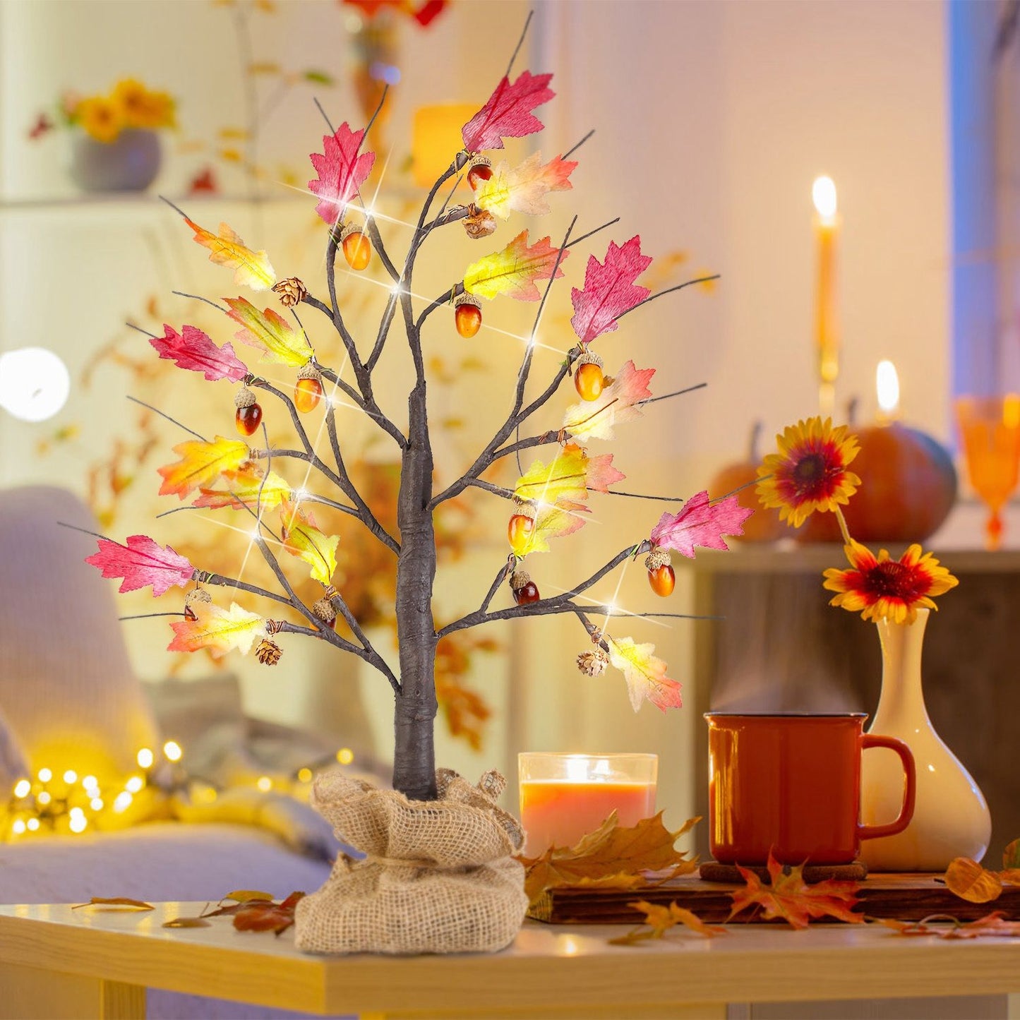 FauxMart.com autumn LED lighted tree with colorful fall leaves and acorns on a cozy living room table