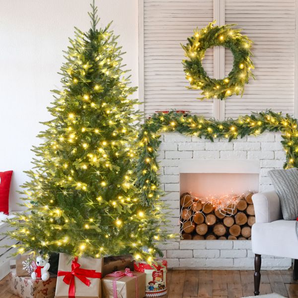 6ft pre-lit Aspen fir Christmas tree adorned with warm white lights and surrounded by festive decorations