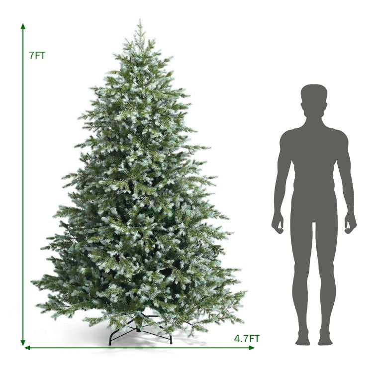 7 foot artificial Christmas tree with green and white frosted branches standing next to human silhouette for size comparison