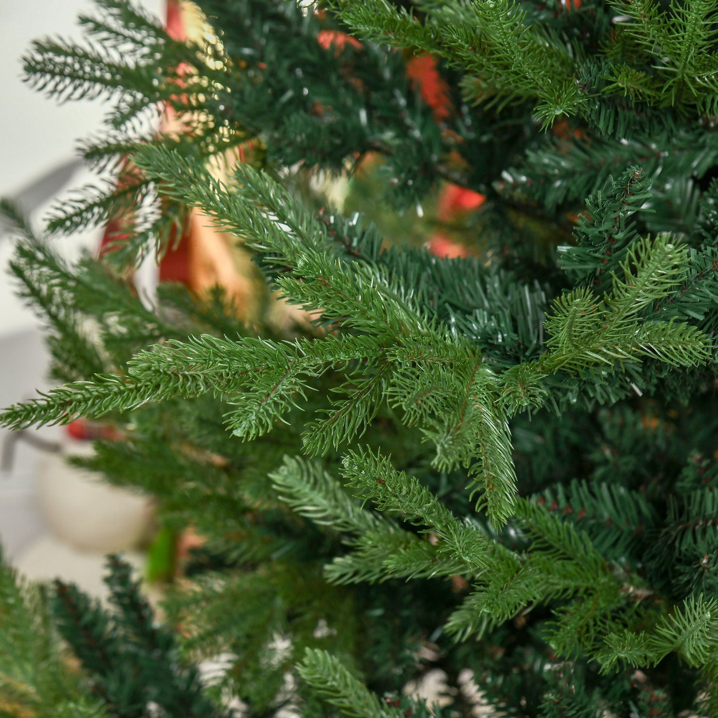 Close-up view of green branches on a 7.5 ft artificial Christmas tree showcasing realistic foliage details