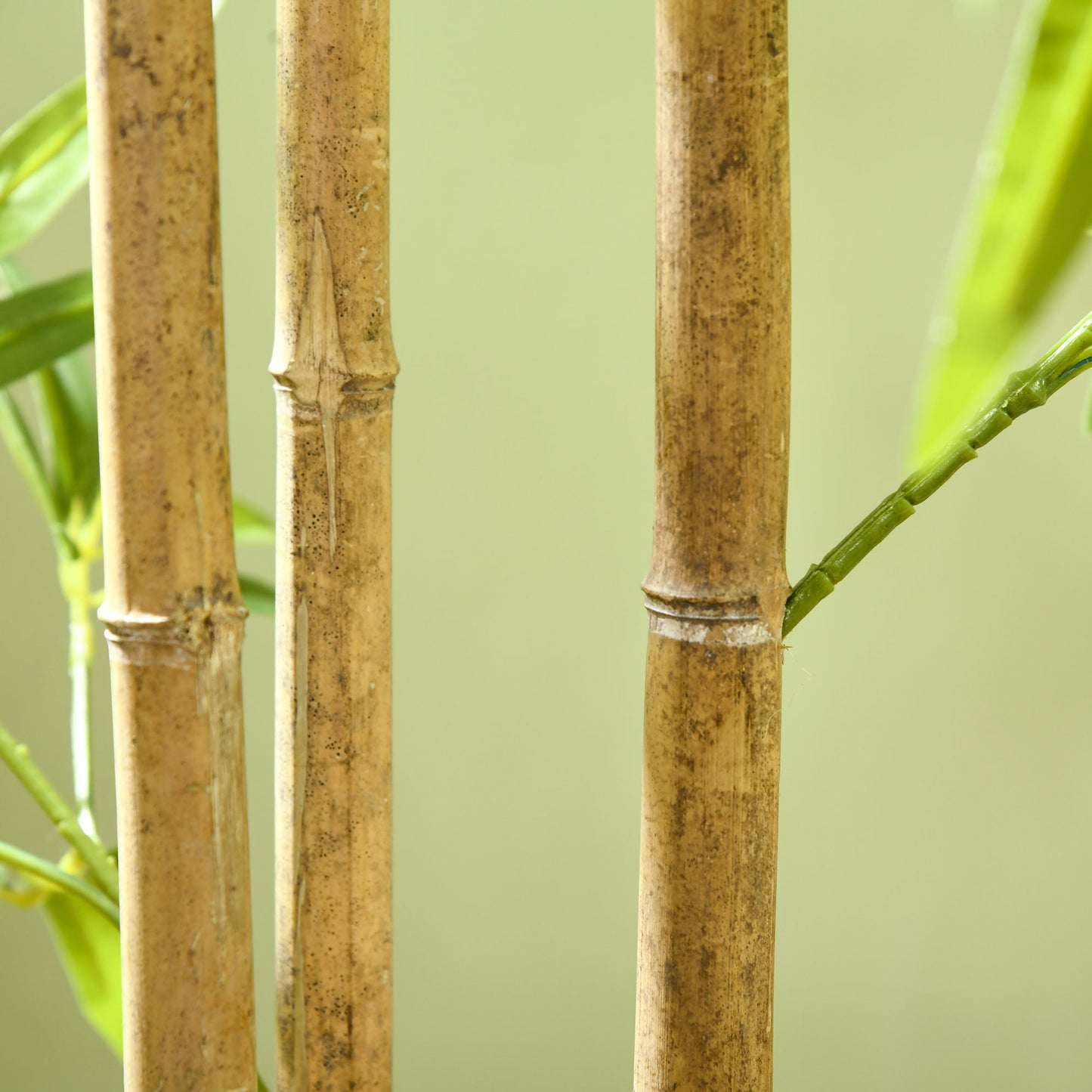 Close-up of artificial bamboo tree 6ft with realistic brown bamboo stalks and green leaves by FauxMart.com