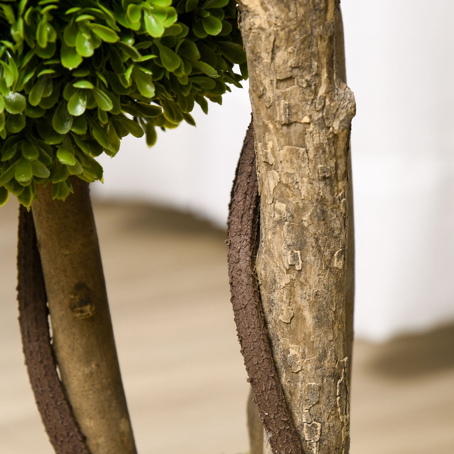 Decorative artificial boxwood topiary balls nestled in a rustic wooden planter for elegant home decor