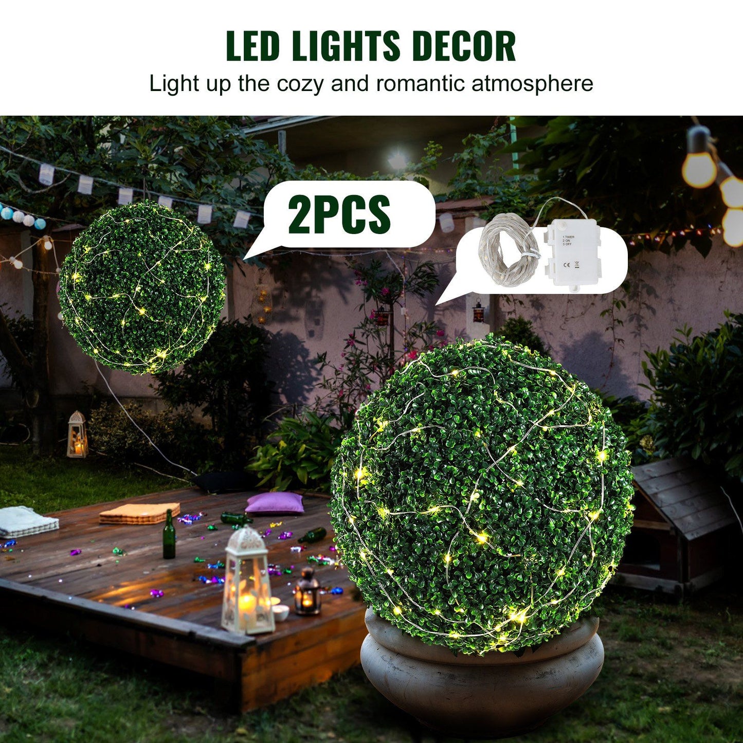 Two artificial boxwood topiary balls decorated with warm LED lights for outdoor romantic decor