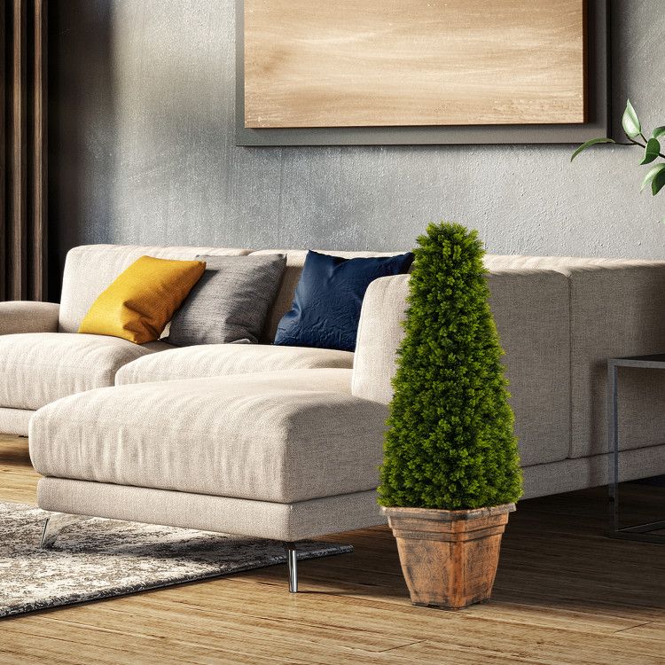 Artificial boxwood topiary tree in a rustic pot, adding greenery to a modern living room