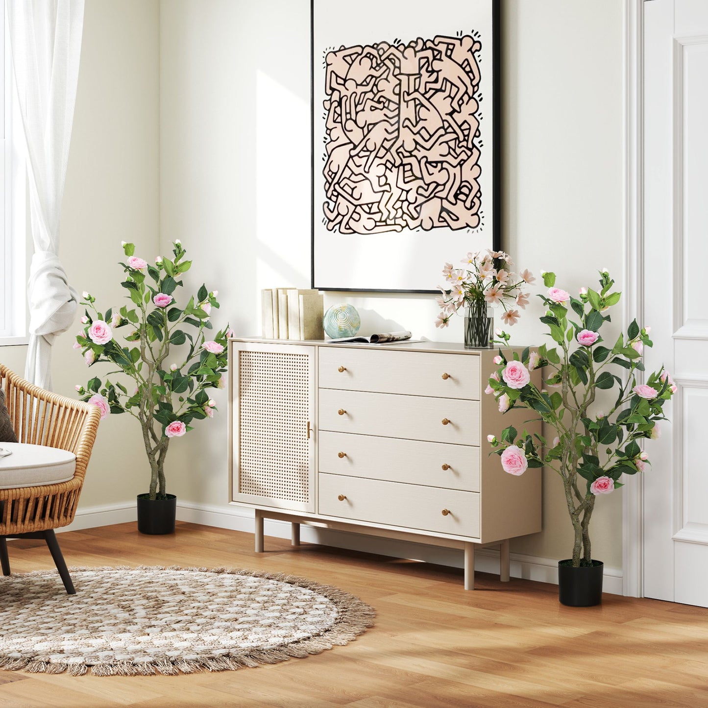 Living room with artificial camellia flowers in pots placed beside a dresser and decorative wall art
