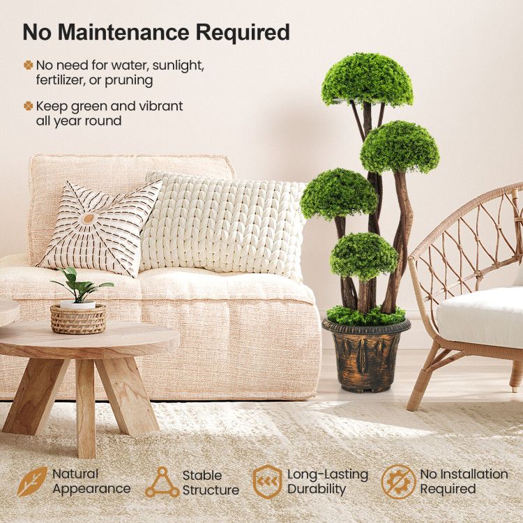 Artificial cedar topiary tree with four green foliage balls in a decorative pot displayed in a cozy living room