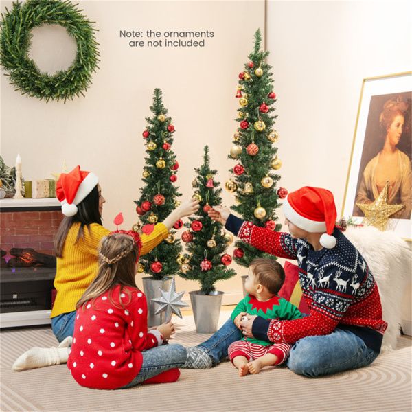 Family decorating artificial Christmas trees set in a cozy living room during the holidays