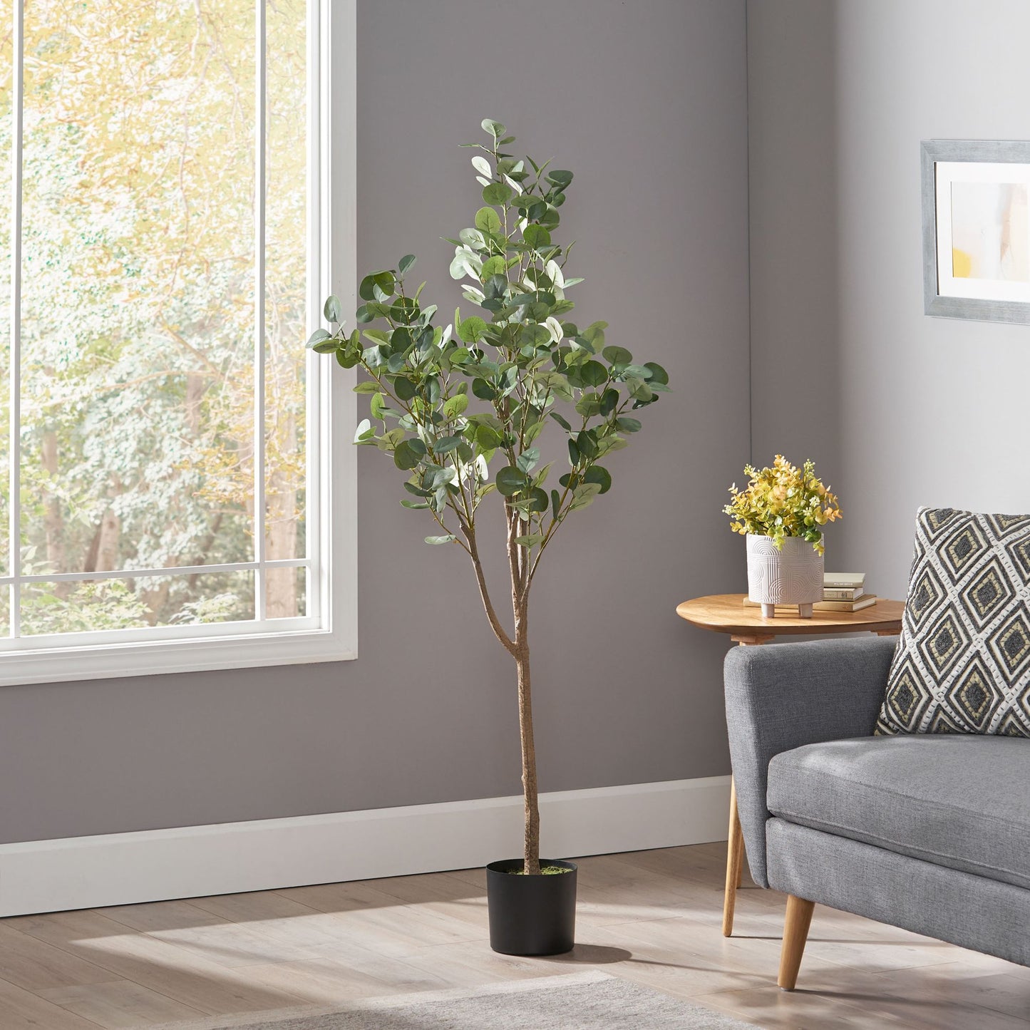 Artificial eucalyptus tree in a modern living room with natural light and stylish decor