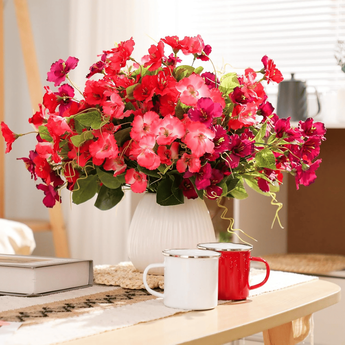 Vibrant arrangement of artificial hibiscus flowers outdoor in a white vase, perfect for home decor