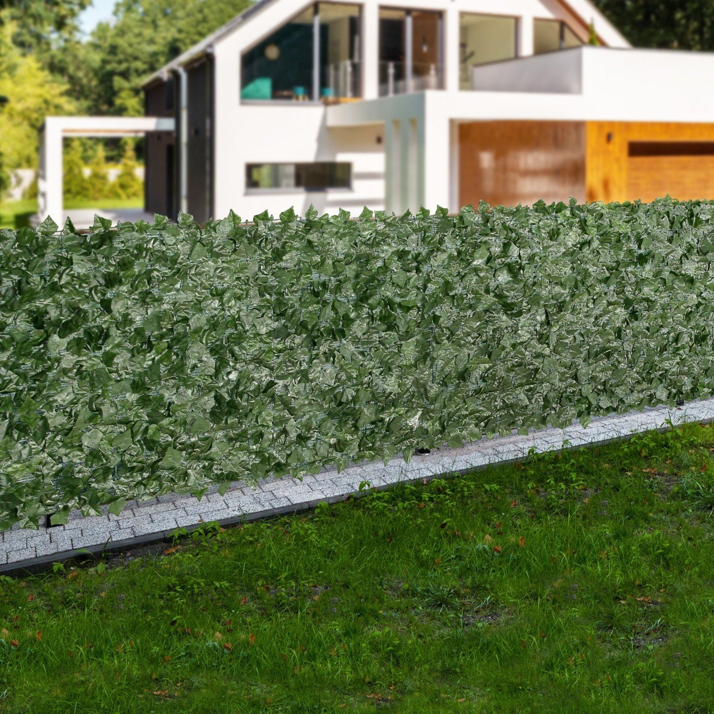 Artificial ivy privacy fence providing green coverage along a modern home exterior yard