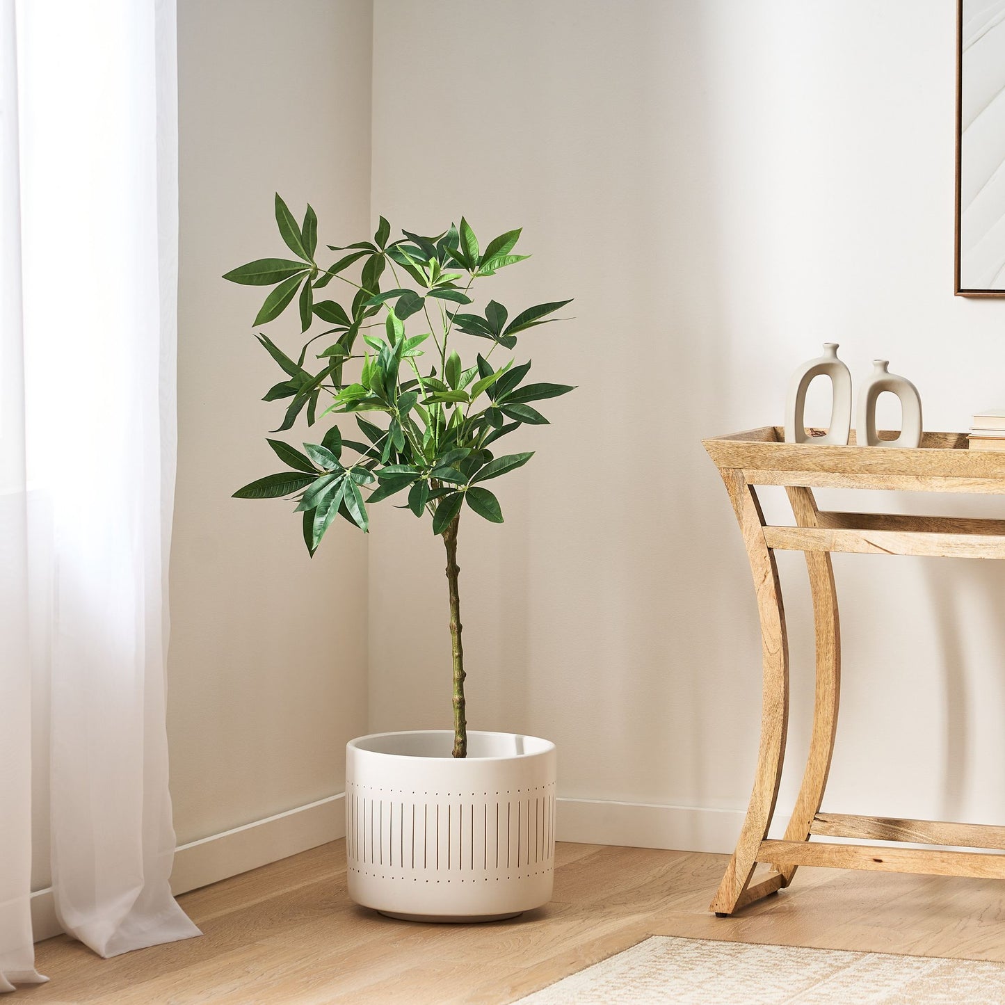 Artificial money tree plant in a modern white pot enhancing home decor in a bright room