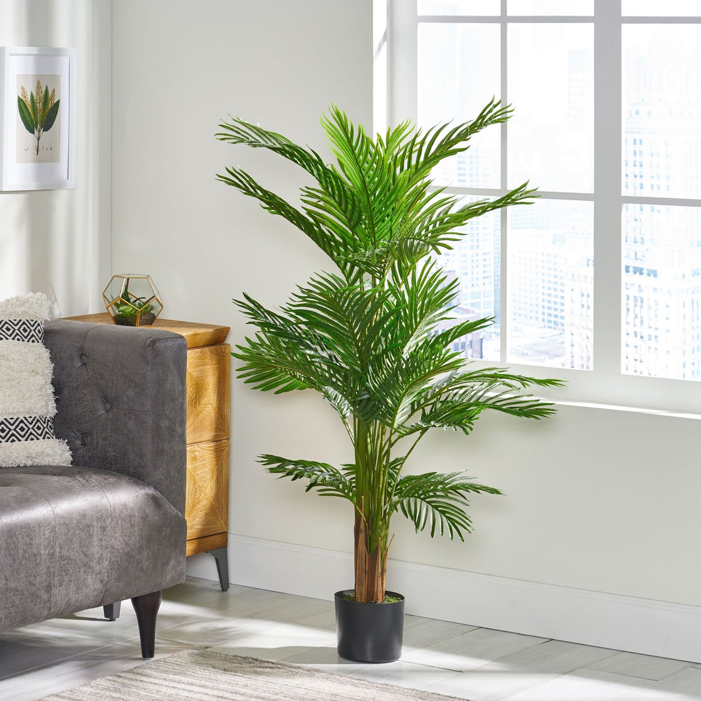 51 inch artificial palm tree in a stylish living room setting next to a gray sofa