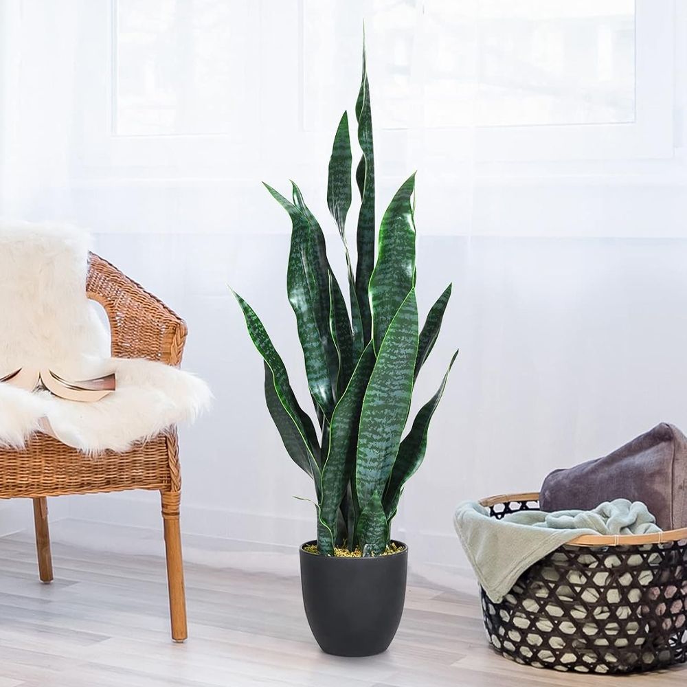 Tall artificial snake plant decor in a modern black pot, perfect for home or office styling