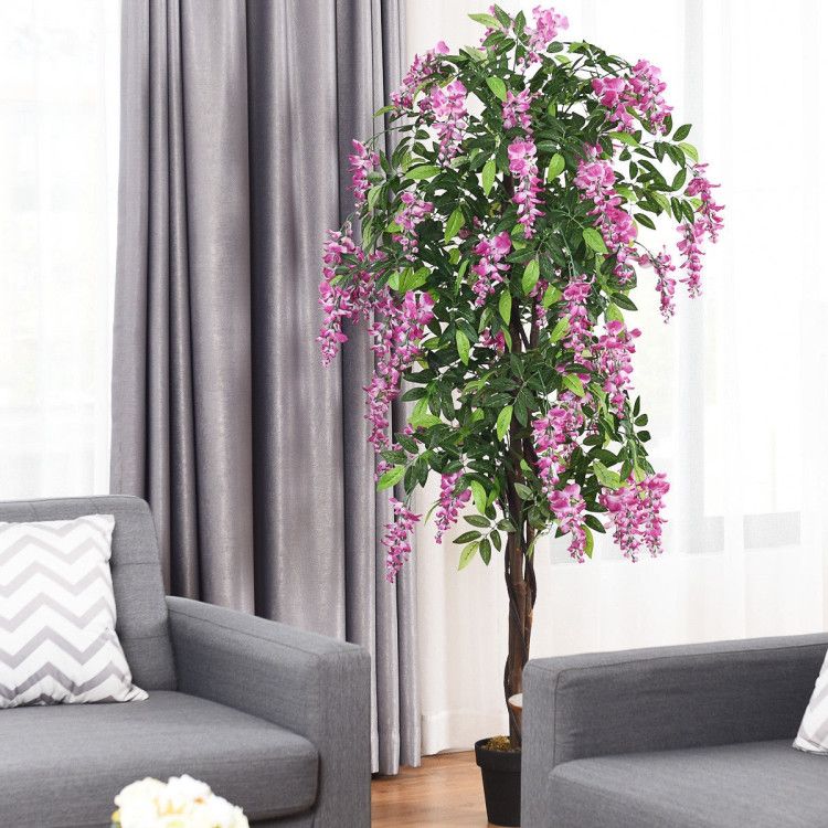 Lifelike artificial wisteria tree in a stylish living room with pink flowers and green leaves