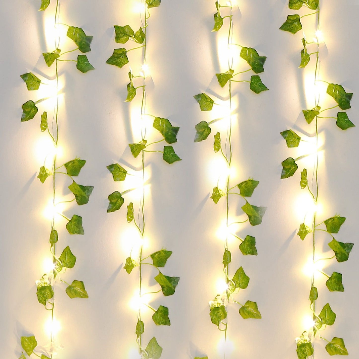 FauxMart.com artificial ivy string lights with glowing warm white bulbs and green leaves for decoration