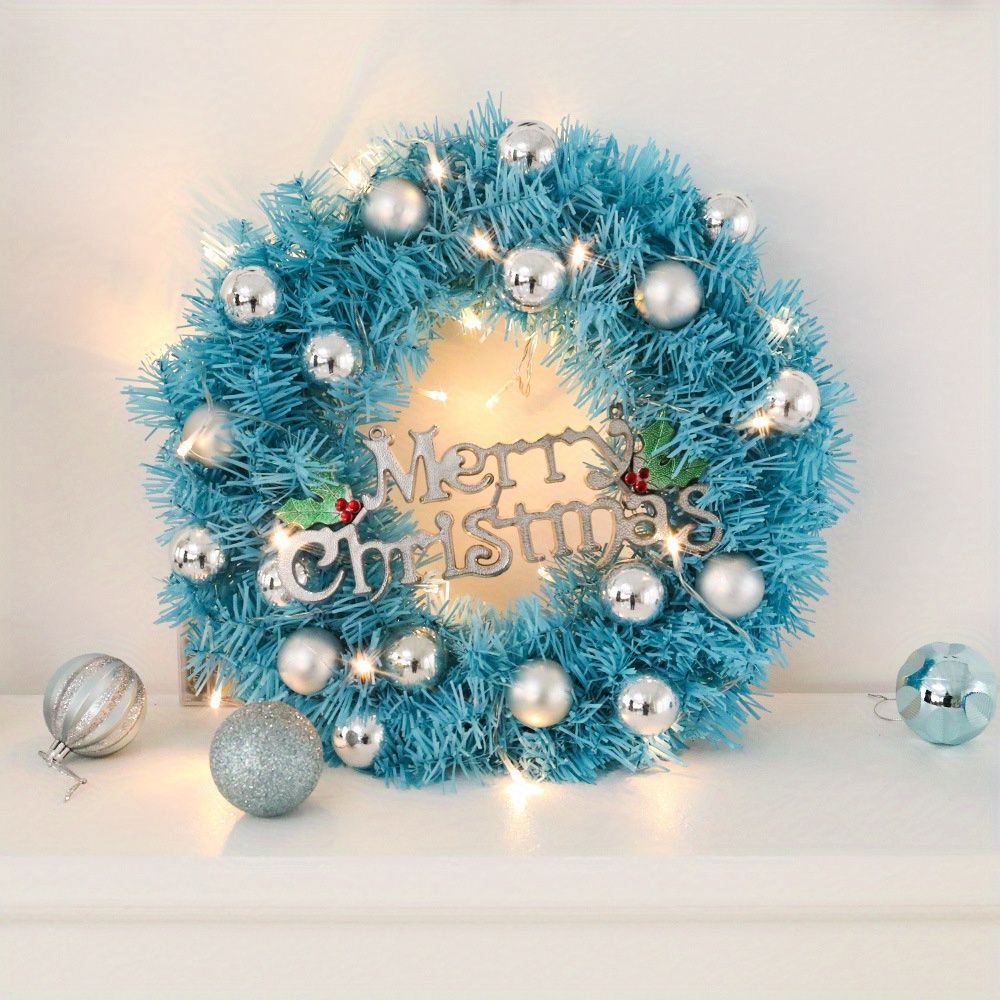 Blue Christmas wreath decor with silver ornaments and lights for festive holiday decoration