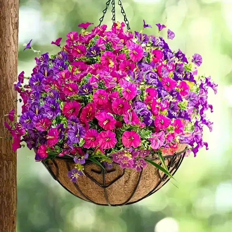 Bright artificial flowers for home in hanging basket with vibrant pink and purple blooms