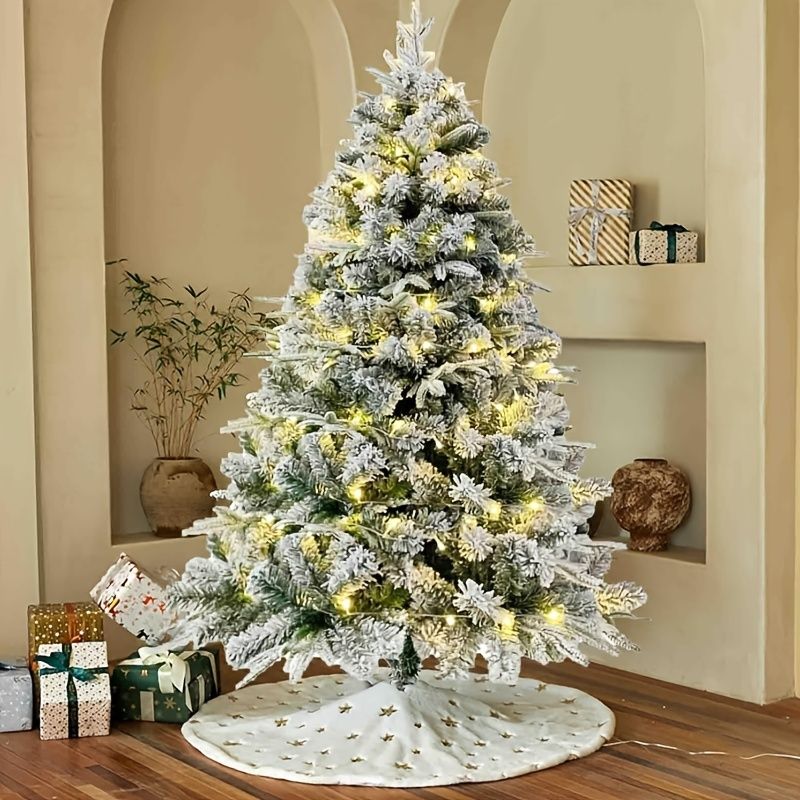 6 ft Christmas tree warm lights with a snowy effect and decorative holiday presents beneath it