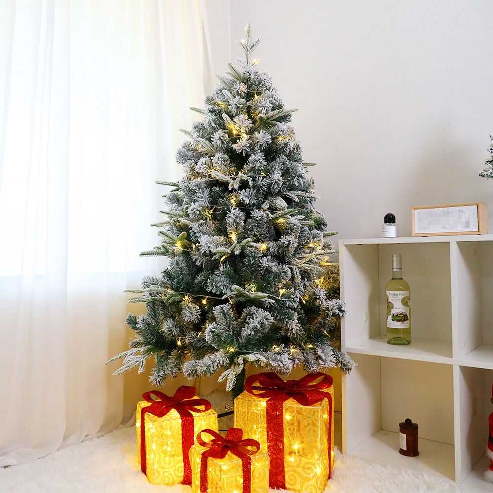 6 ft Christmas tree warm lights decorated with warm glowing lights and gift boxes beneath