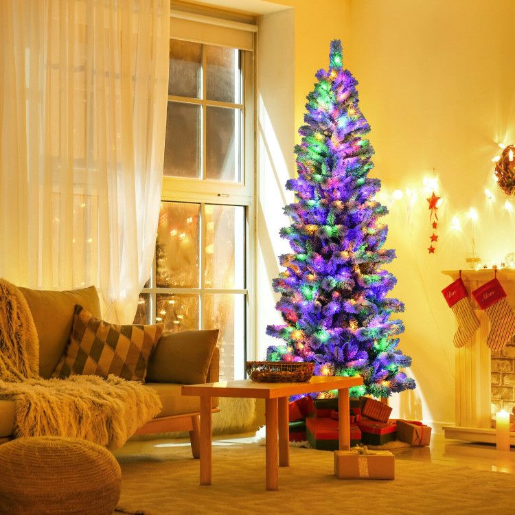 Christmas tree with 9 lighting modes brightly lit in a cozy living room with presents and holiday decorations