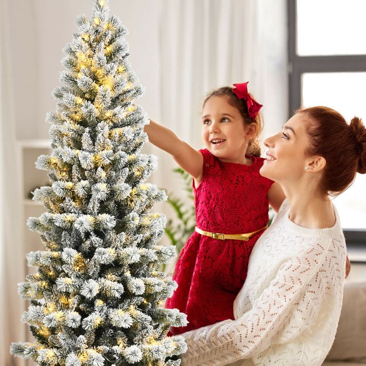 Christmas tree with 9 lighting modes decorated in a cozy living room with a smiling mother and daughter