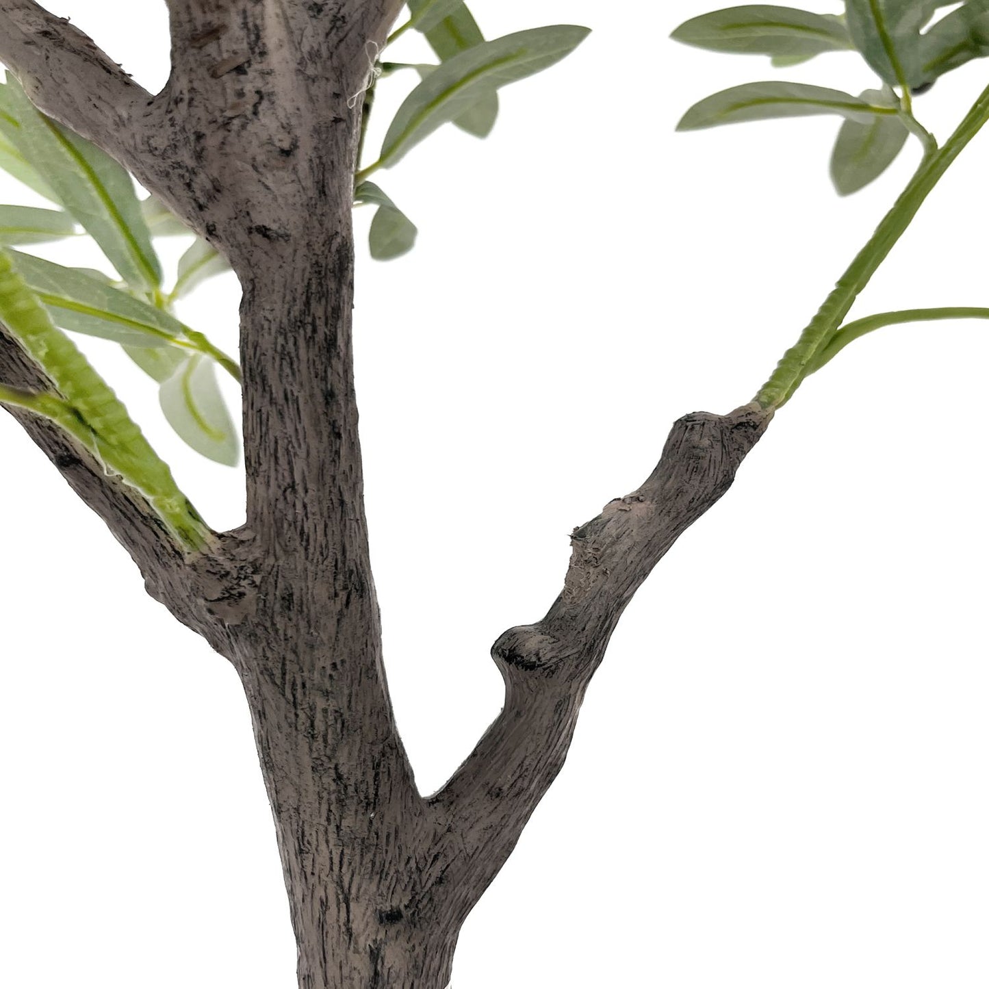 Close-up of a decorative faux olive tree branch with realistic green leaves and textured trunk
