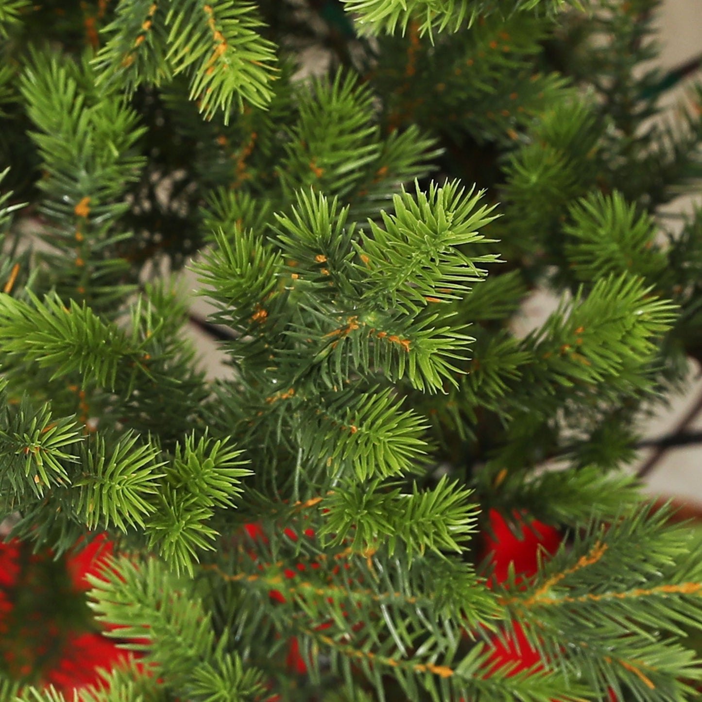 Close-up of a sparse artificial Christmas tree with realistic green foliage and sturdy branches