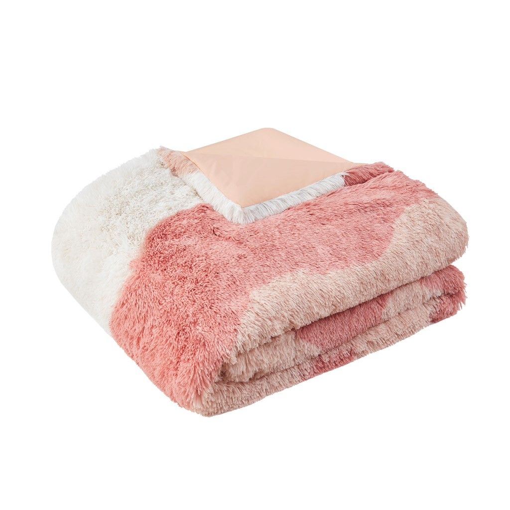 Ombre faux fur comforter set folded showing soft texture in pink and cream colors