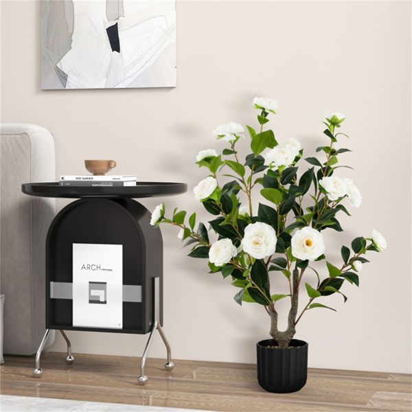 Elegant faux camellia trees in a stylish pot beside a modern side table in a cozy living room