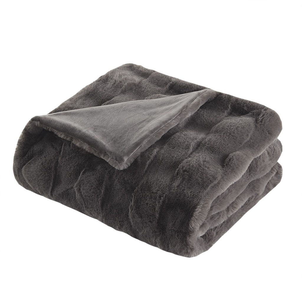Cozy dark gray faux fur throw blanket folded neatly with soft plush texture