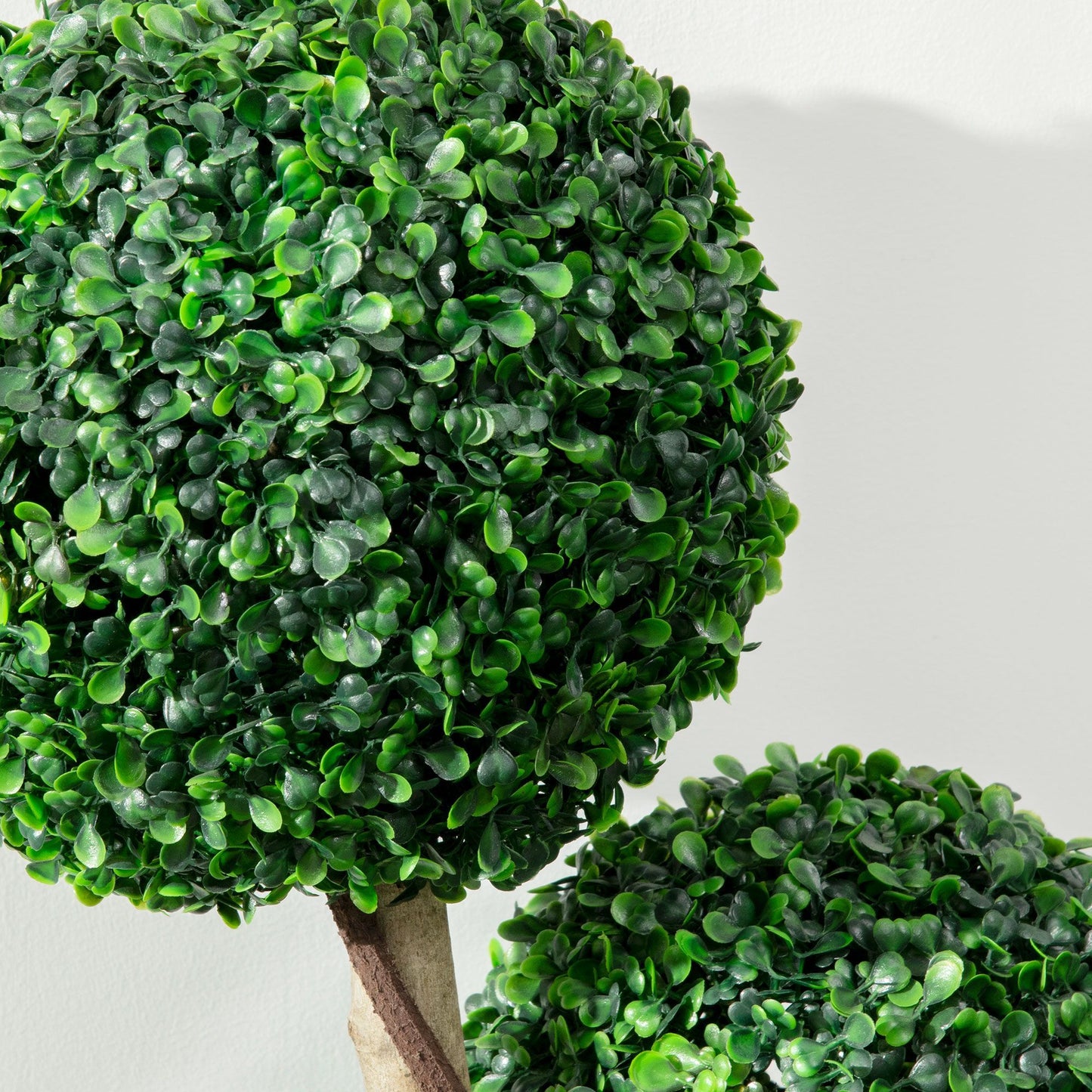 Close-up of artificial boxwood topiary tree with dense green leaves from FauxMart.com