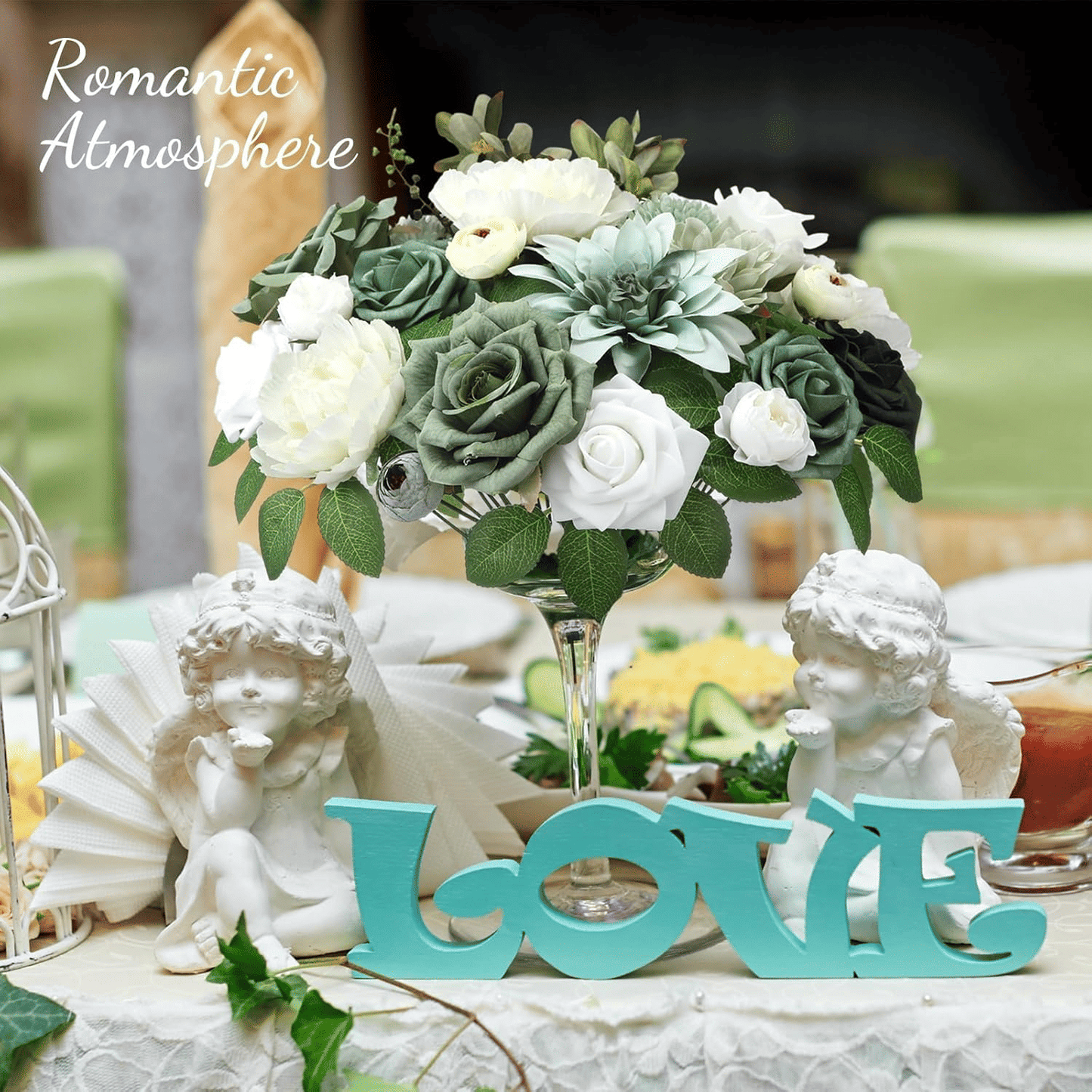 White and green artificial flower arrangement centerpiece with decorative love sign and angel statues