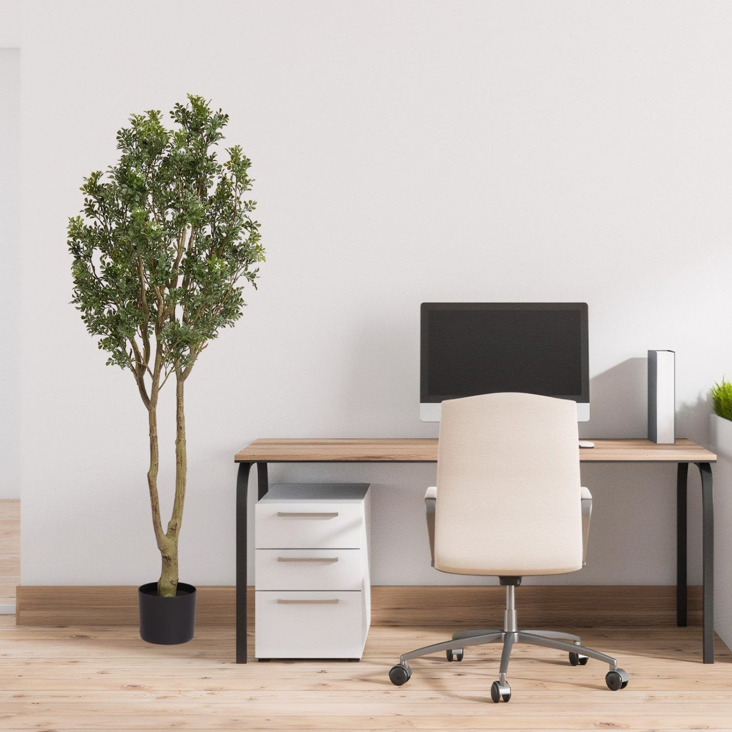 Large artificial plants displayed beside a modern office desk to enhance workspace decor