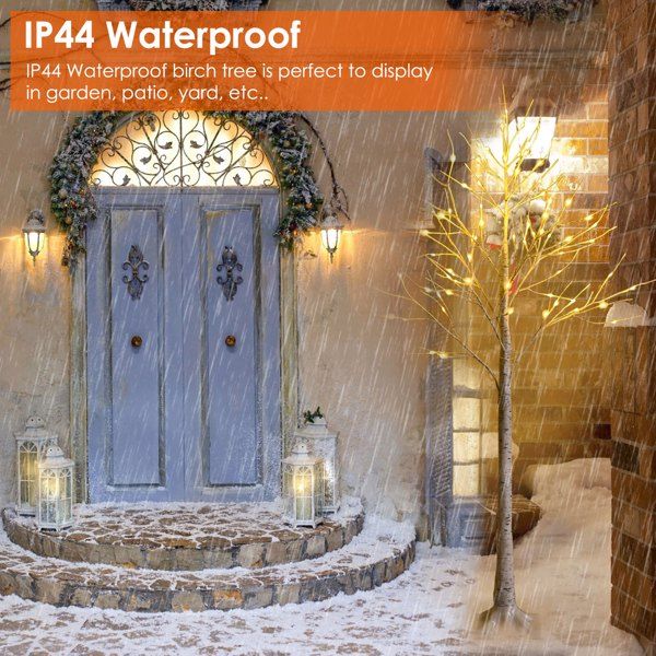 IP44 waterproof lighted birch tree decor glowing beside a brick house entrance in snowy rain
