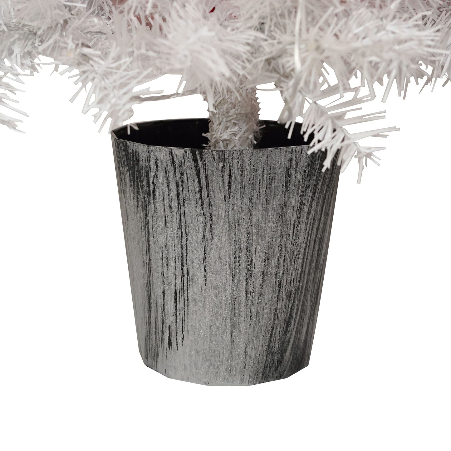 Close-up of silver tree stand base for lighted santa hat christmas tree with white branches