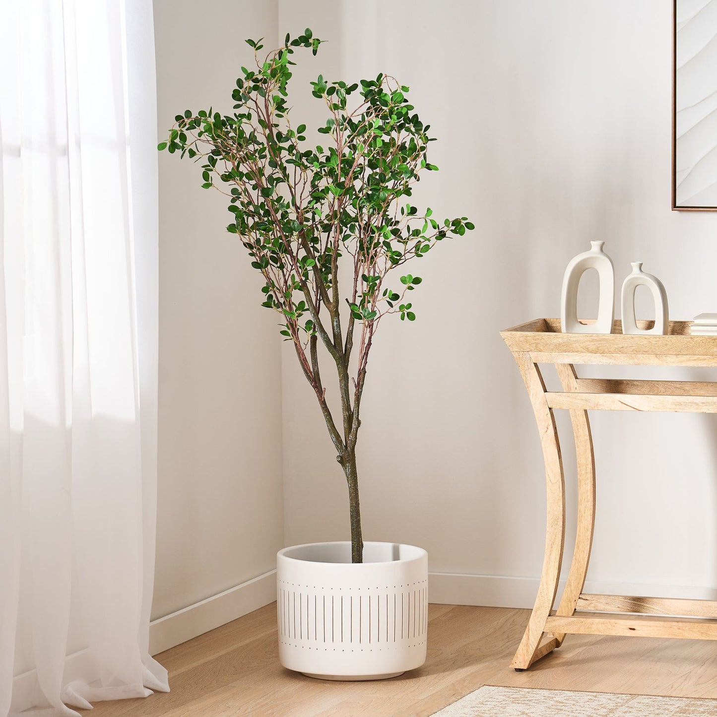 Milan leaf artificial plant in a white pot, adding a touch of greenery to modern home decor