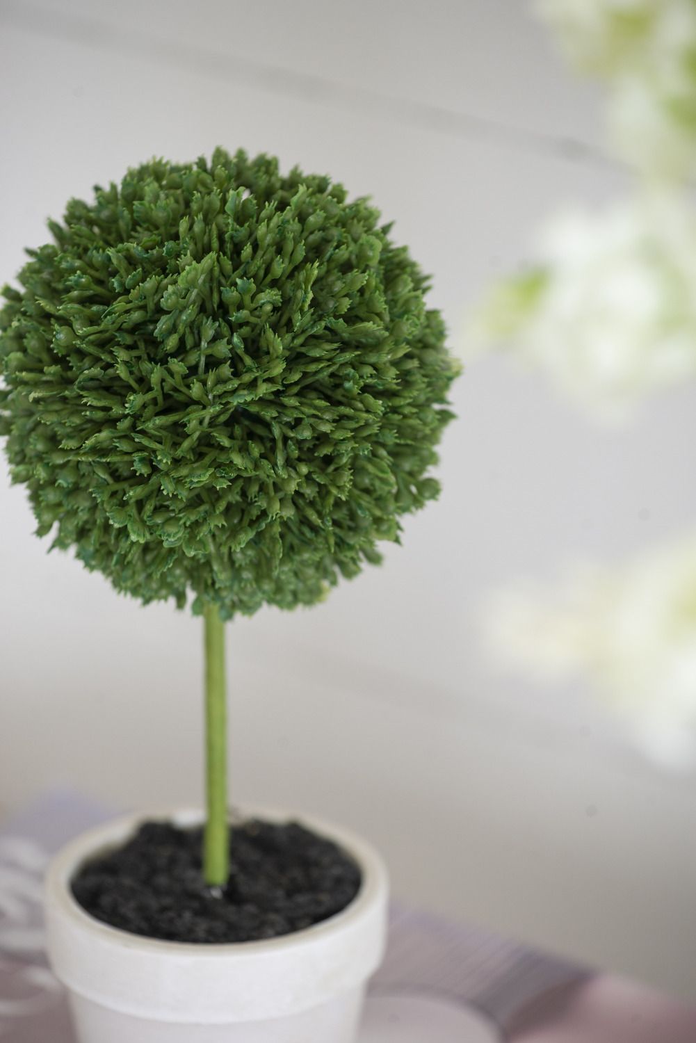 Mini faux topiary set featuring a green spherical plant in a white pot for home decor