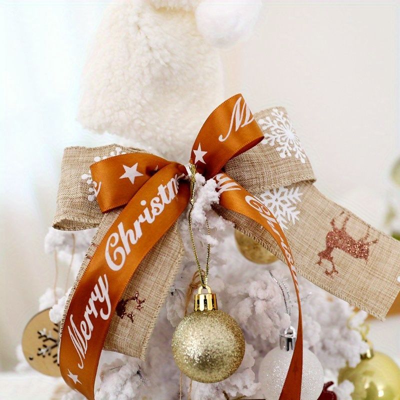 Decorative mini table top Christmas tree adorned with ornaments and a festive bow