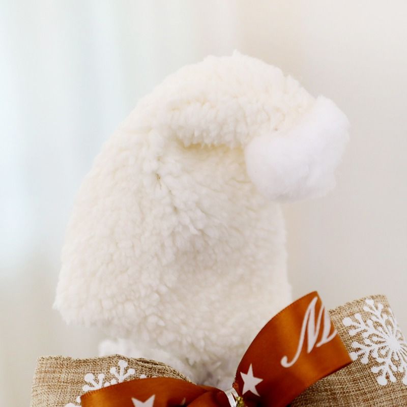 Cute mini table top Christmas tree with a fluffy white hat and decorative burlap base