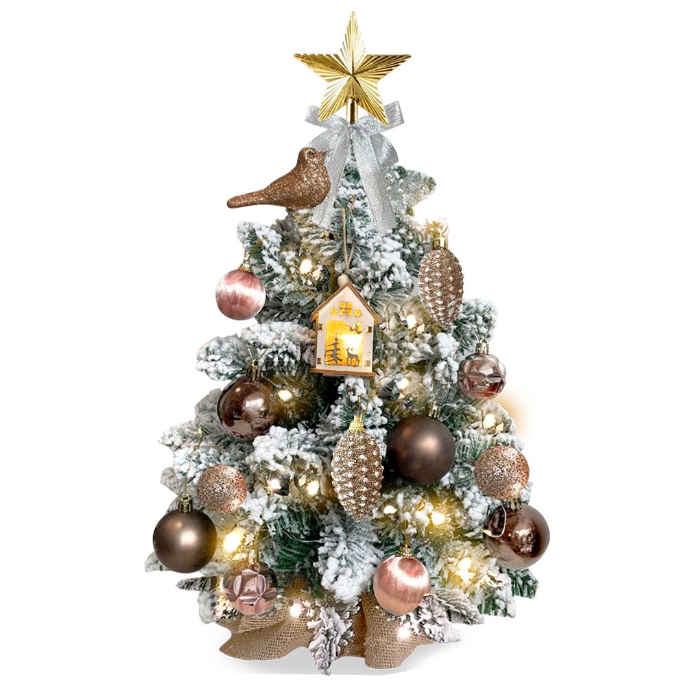 Mini tabletop Christmas tree with lights decorated with gold star, bird ornament, and assorted baubles