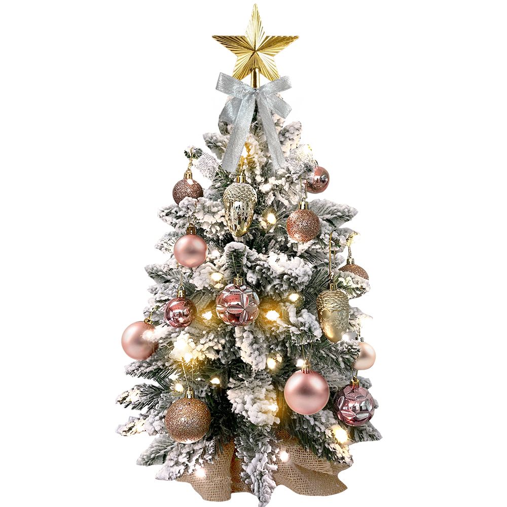 Mini tabletop Christmas tree with lights decorated with frosted branches and pink and gold ornaments