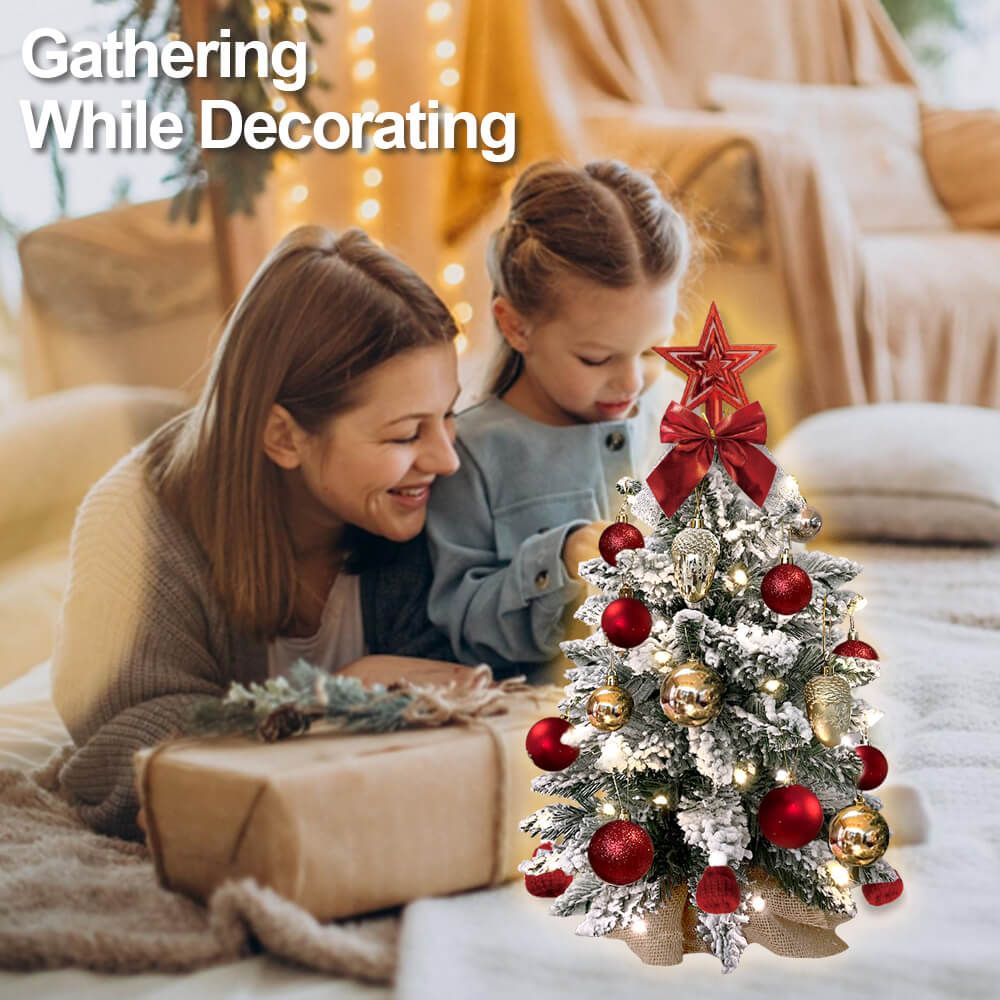 Mini tabletop Christmas tree with lights decorated with red and gold ornaments and a red star topper