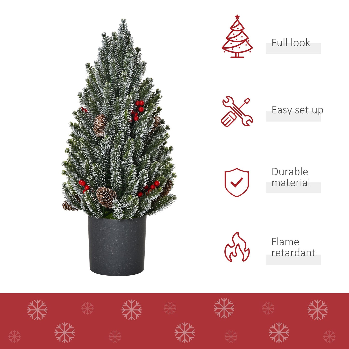 Miniature snow flocked Christmas tree with pinecones and red berries in a black pot