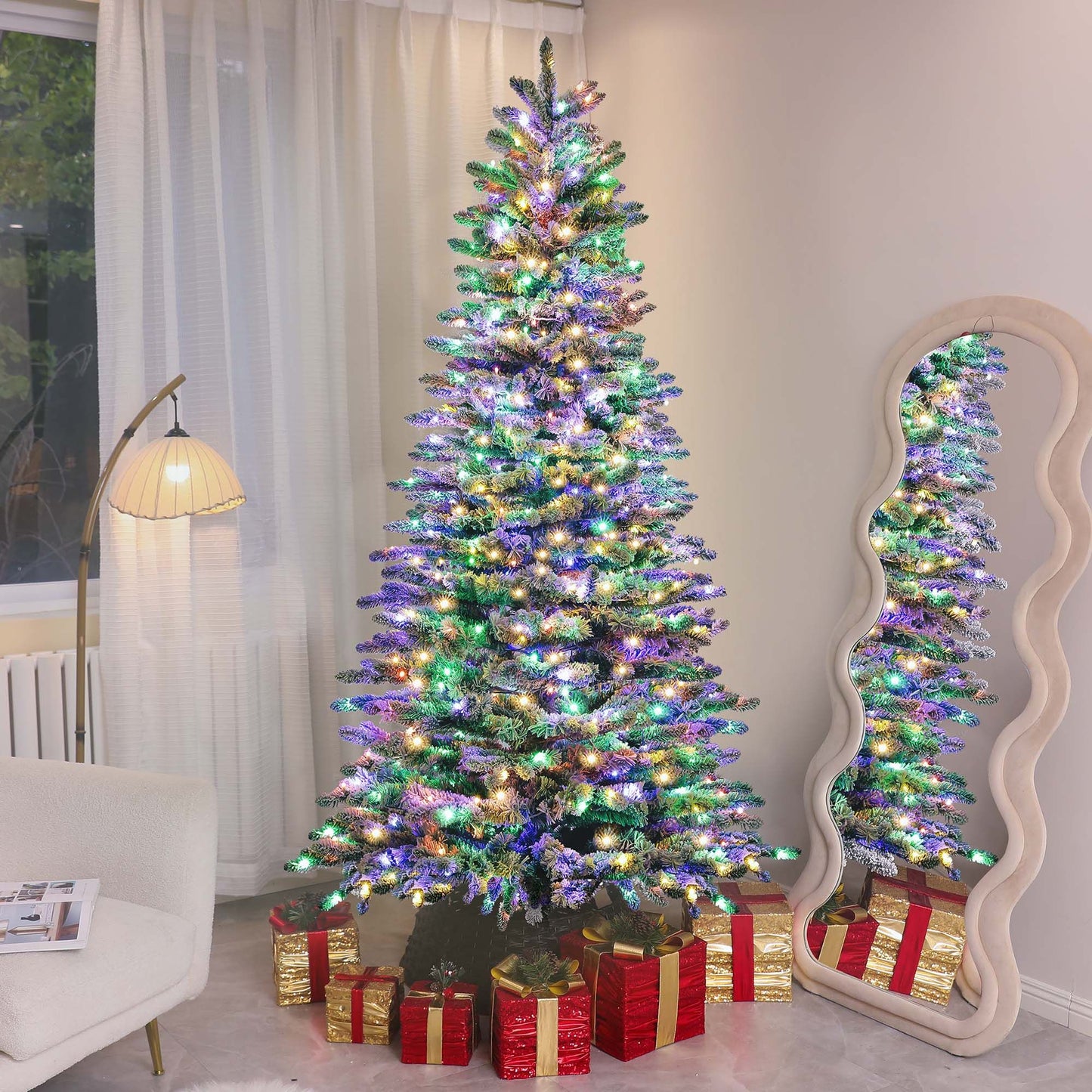 Mountain pine artificial Christmas tree decorated with colorful lights and surrounded by red and gold wrapped gifts