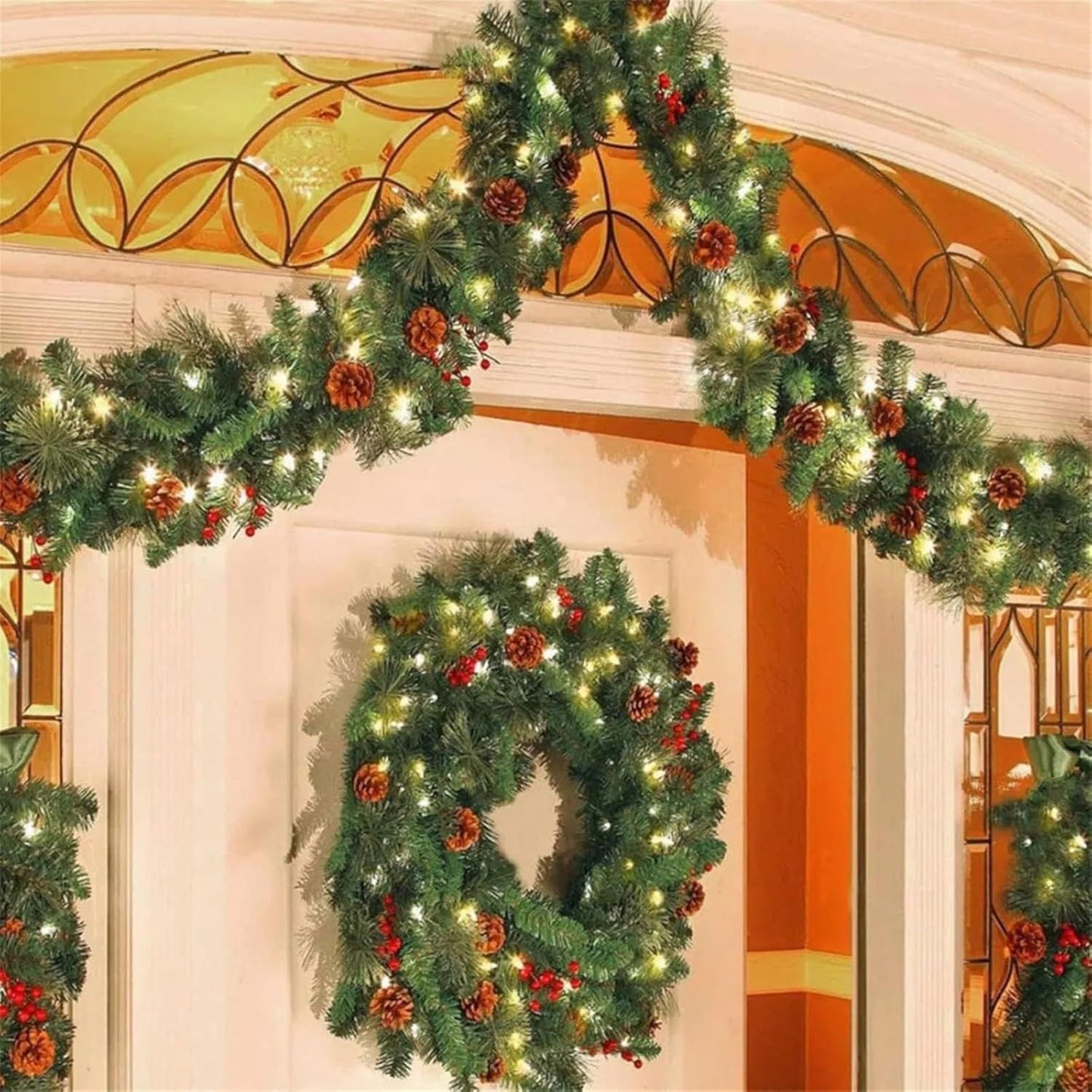Prelit artificial Christmas garland adorned with pinecones and red berries for festive holiday decor