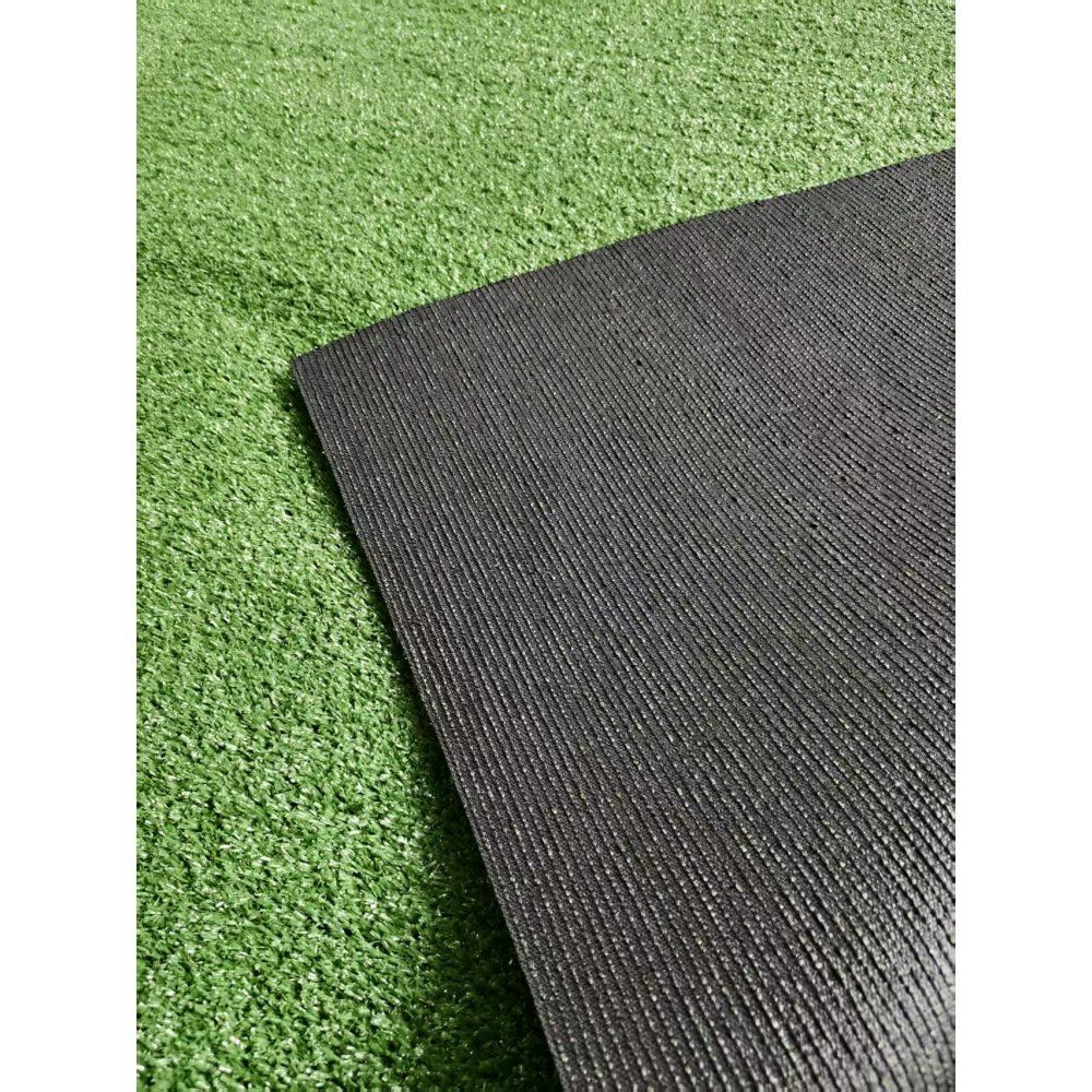 Premium artificial turf mat in black on green grass for versatile indoor and outdoor use