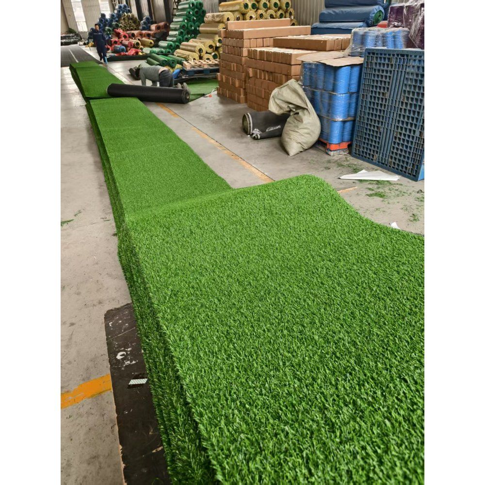 Rolls of premium artificial turf mat stacked for landscaping and outdoor use in a warehouse