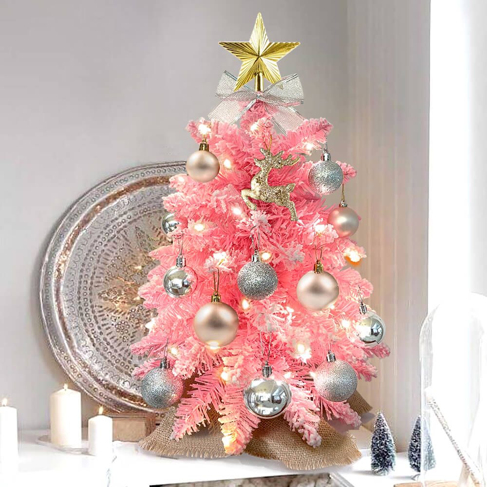 Pink small Xmas tree for office desk decorated with silver and gold ornaments and a gold star topper