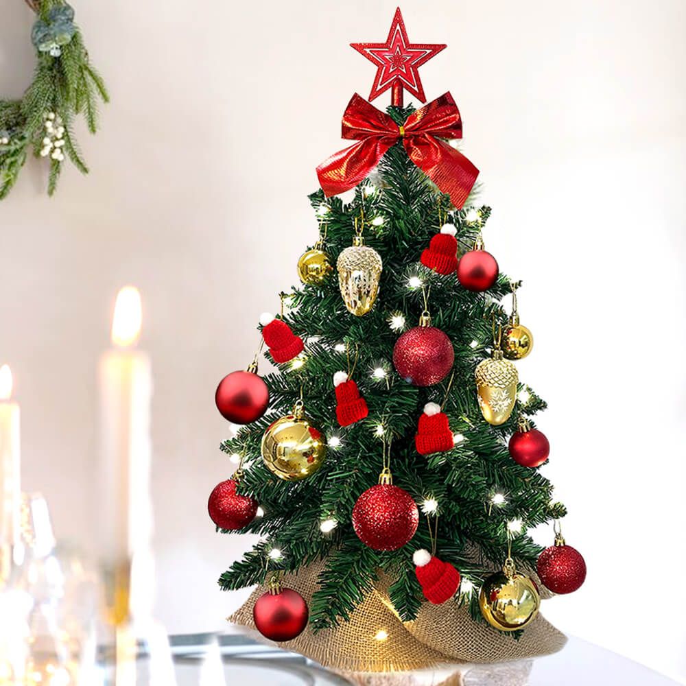 Small Xmas tree for office desk decorated with red and gold ornaments and red star topper
