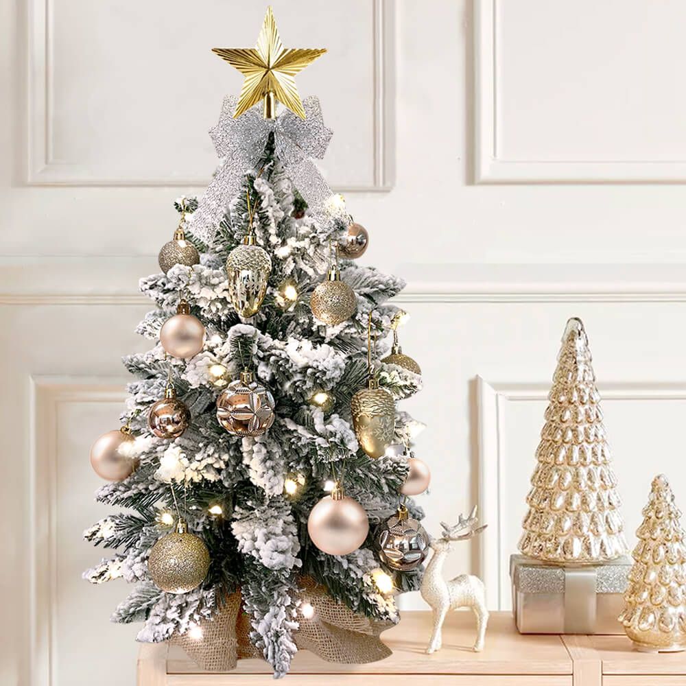 Small Xmas tree for office desk decorated with gold and silver ornaments and warm white lights